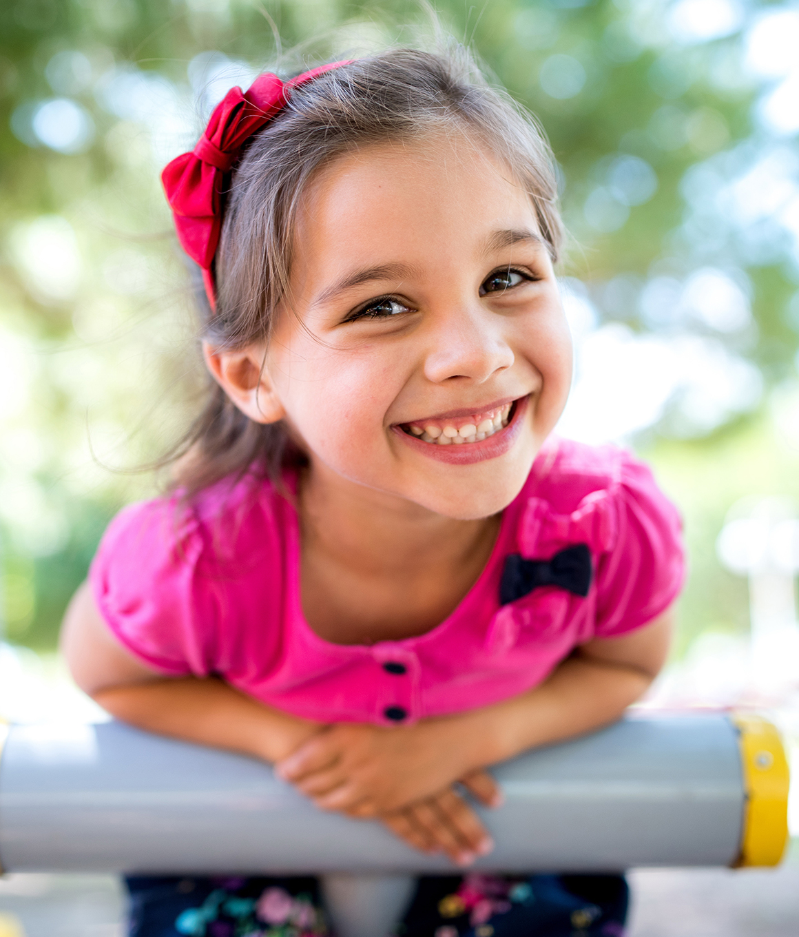 Young girl grinning on outdoor playground