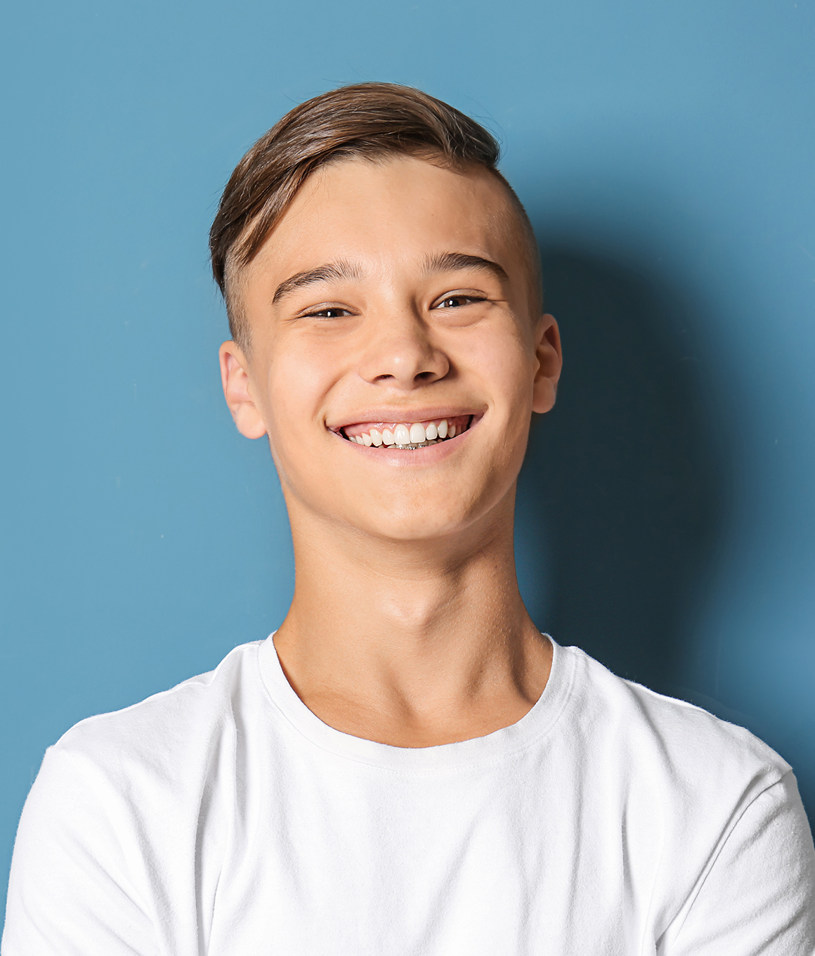 Smiling teenage boy with blond hair