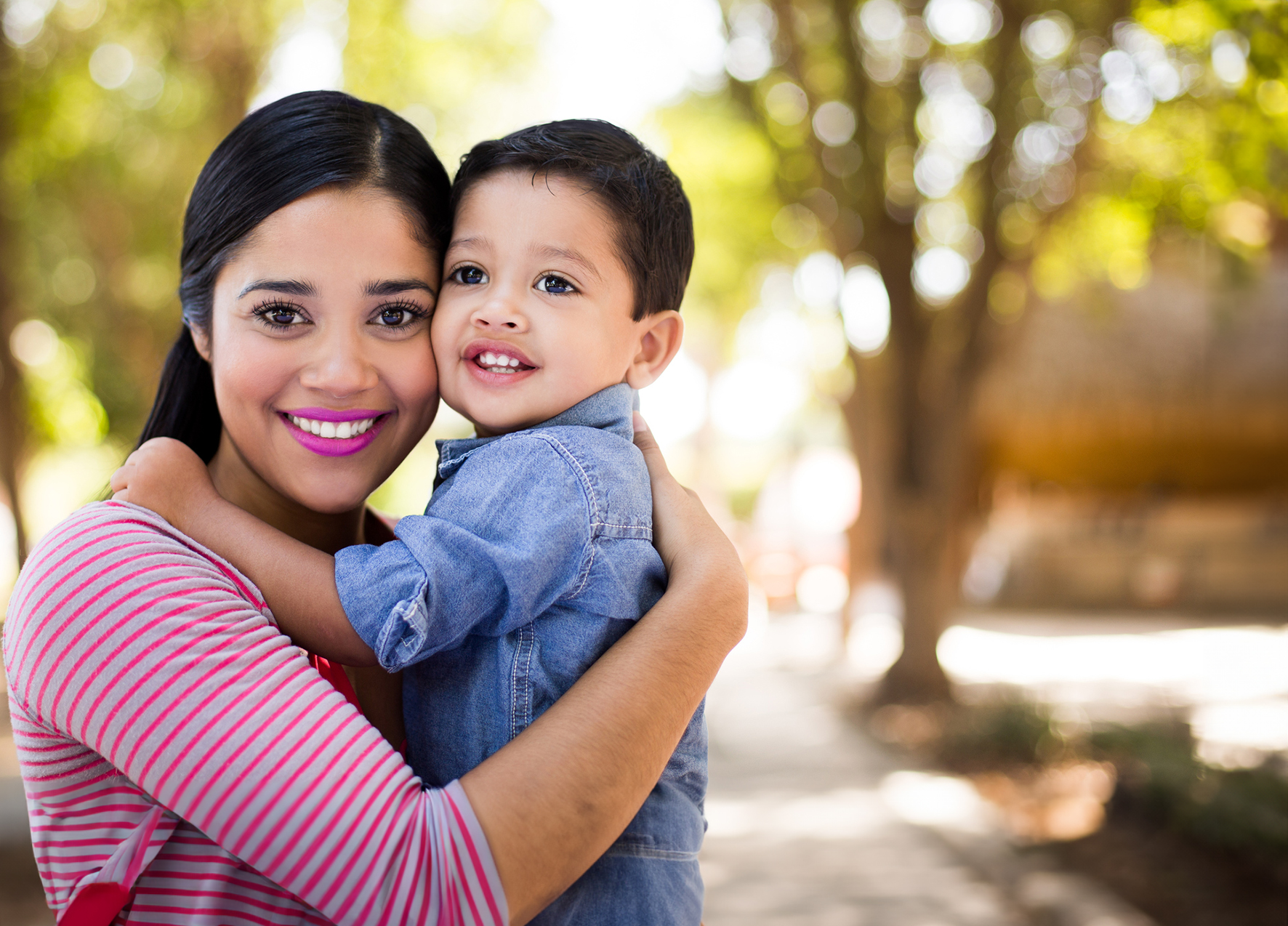 Woman holding her young son after visiting dentist for toddlers in Murphy