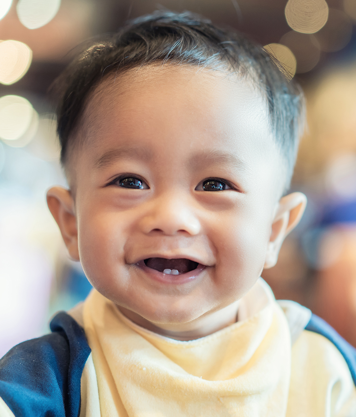 Toddler smiling with only two lower teeth