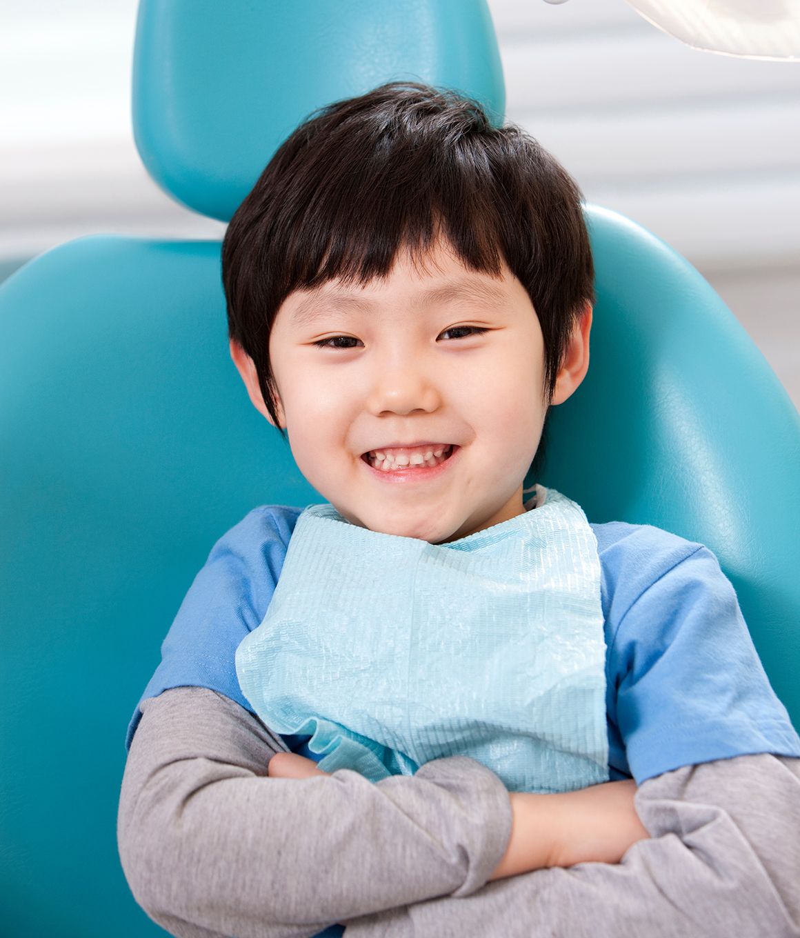 Young boy smiling in dental chair