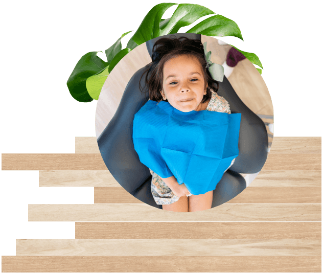 Girl in dental chair looking up with two green leaves and horizontal wood stripes