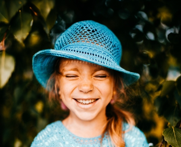 Smiling young girl in blue knit hat