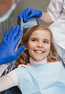 Child smiling and giving dentist a high five