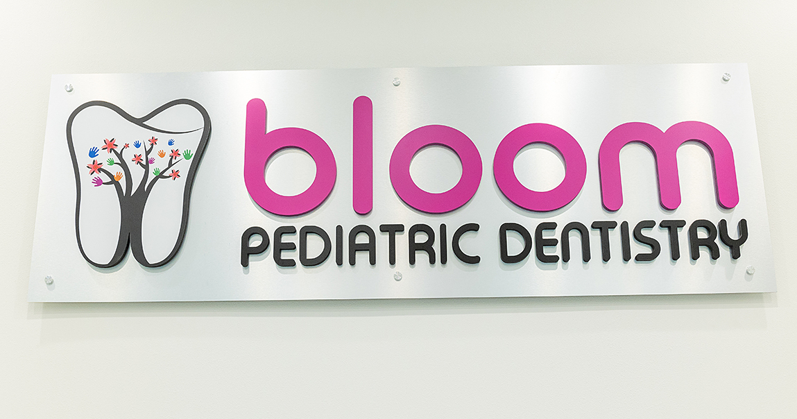 Bloom Pediatric Dentistry sign on wall