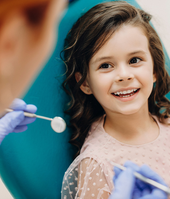 Child holding their lost tooth