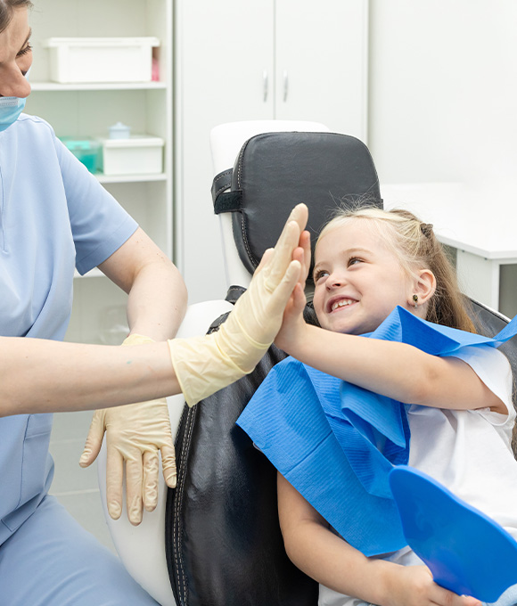 Child holding their lost tooth