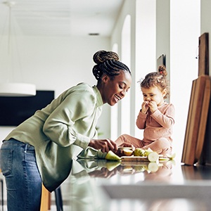 Mom and child eating healthy snack together at home