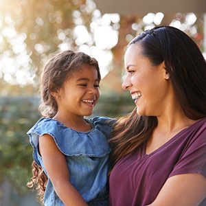 Child and parent smiling at each other