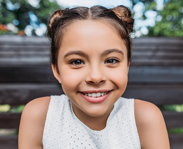 Young girl with space buns smiling