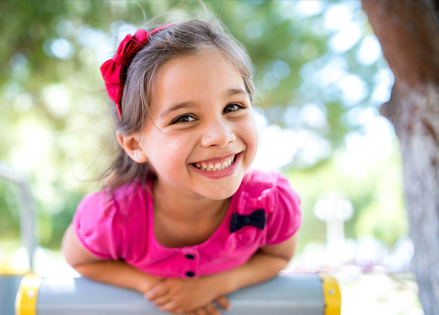 Young girl smiling on outdoor playground