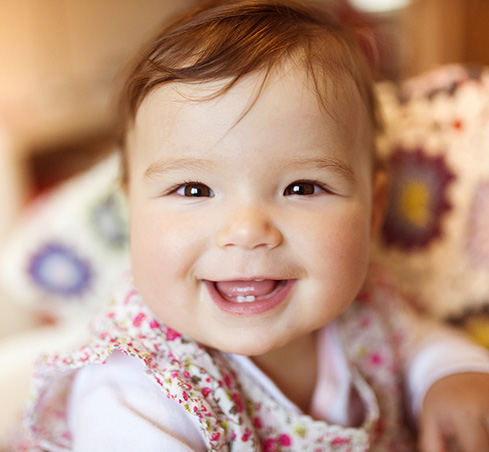 Smiling toddler with only two lower teeth