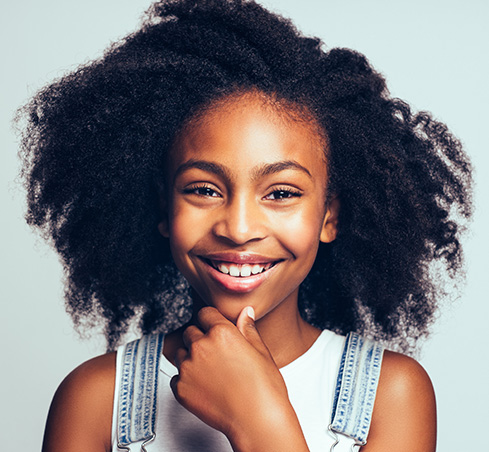 Girl in overalls smiling