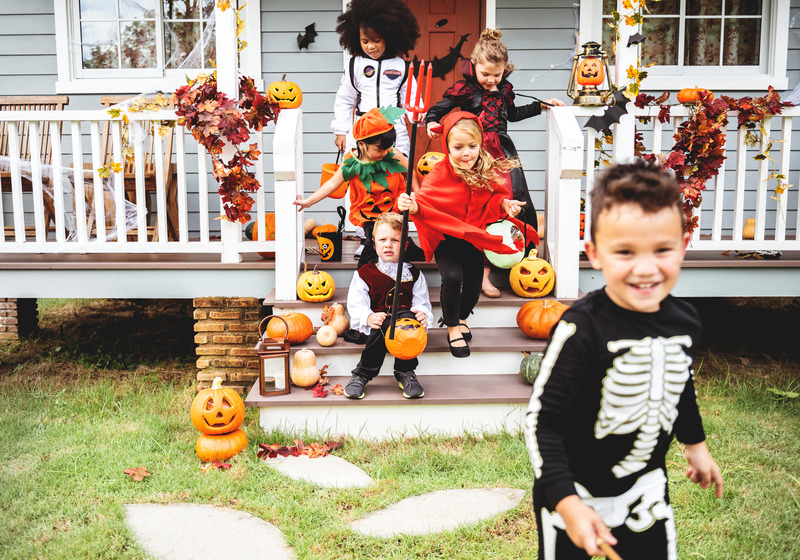 Children smiling in Halloween costumes